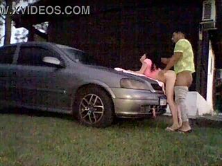 Amateur couple tries out shock absorbers on car's hood